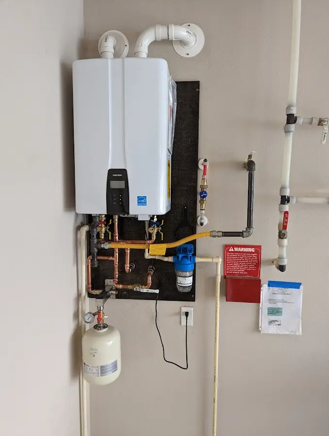 Professional plumber installing copper piping in a Fort Lee home